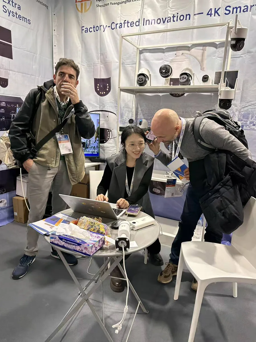 Discussing specifications with distributors at an international security exhibition